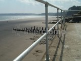 Beach front safety barrier made with Interclamp tube fittings overlooking sand and sea 